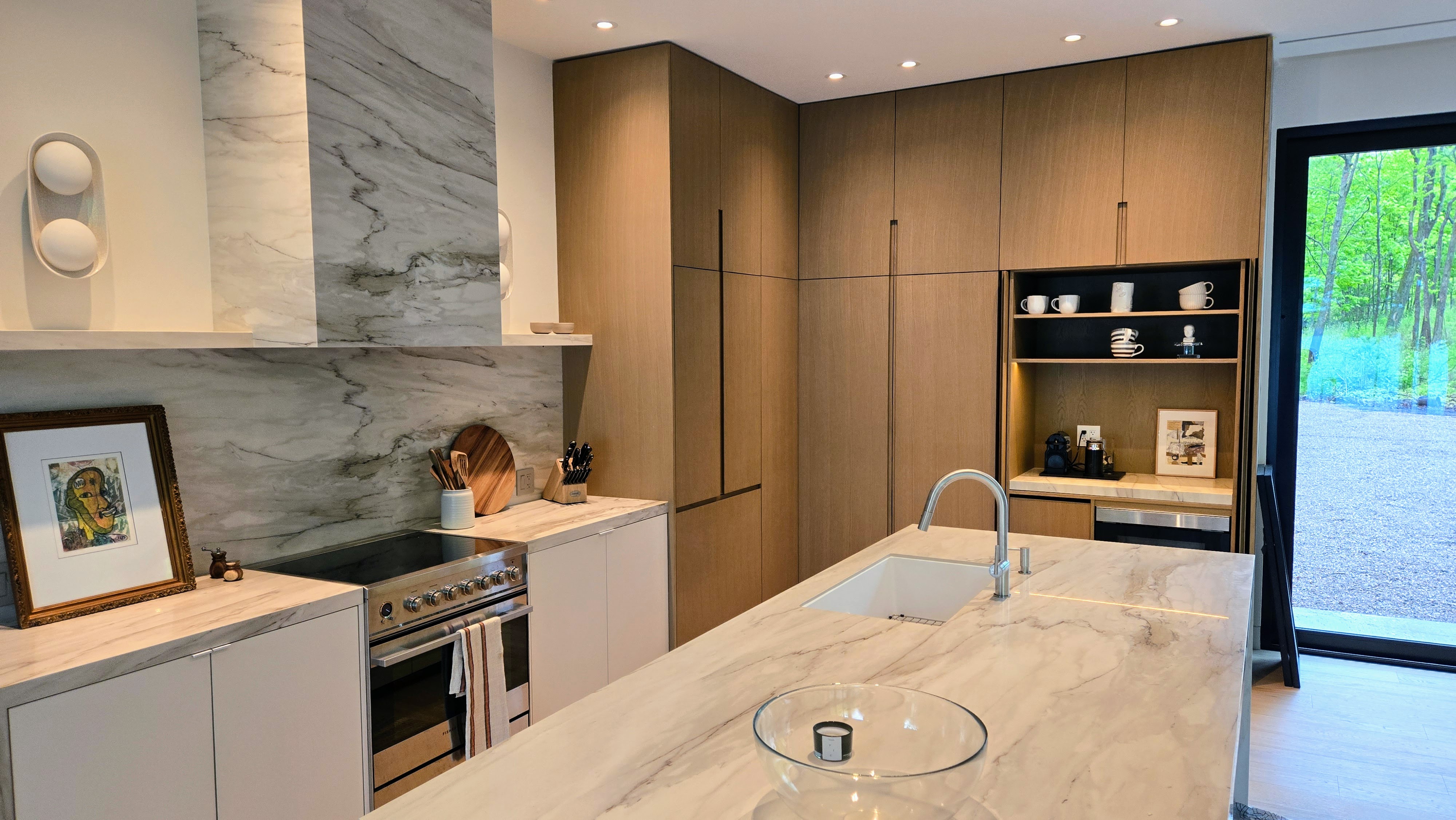 White oak cabinets with sintered stone island